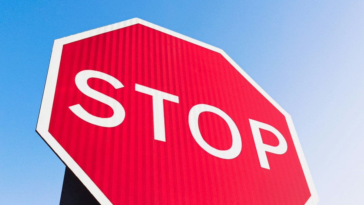 A stop sign with a blue sky in the background. — a Sleep Finally guide to When Naps Stop Working: Signs to Cut Them Out.