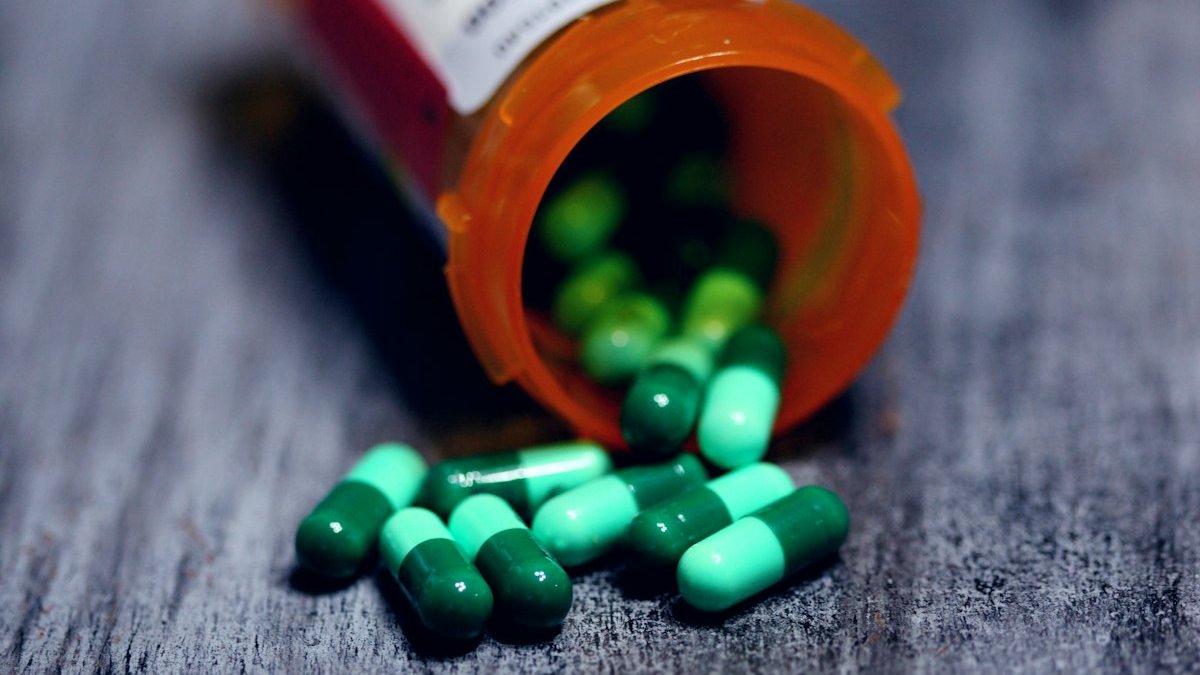Shallow focus photography of prescription bottle with capsules. — a Sleep Finally guide to When to Take Melatonin for Jet Lag.
