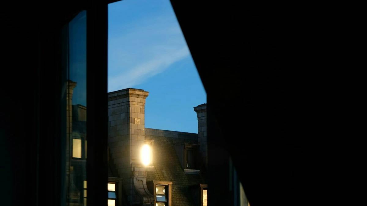 a view of a building through a window — a Sleep, Finally guide to Why Cortisol Spikes at Night and Keeps You Awake
