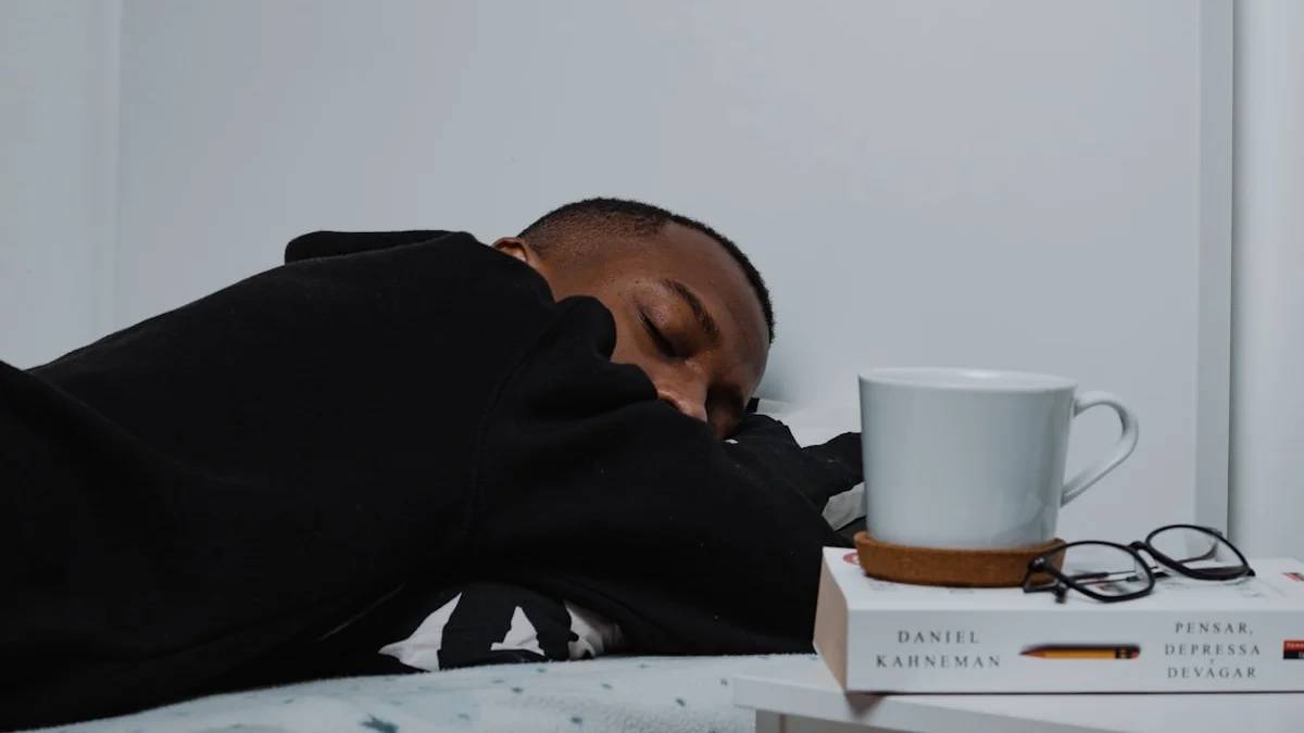 a man sleeping on a bed next to a stack of books — a Sleep, Finally guide to Why Night Shifts Upset Your Stomach
