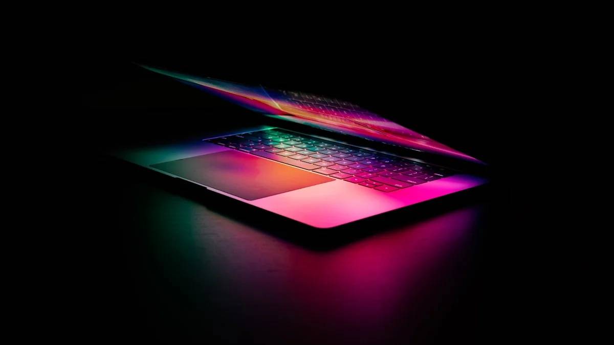A laptop with a glowing keyboard illuminated by vibrant pink and green light — a Sleep, Finally guide to Why Screens Trick Your Brain Into Staying Awake