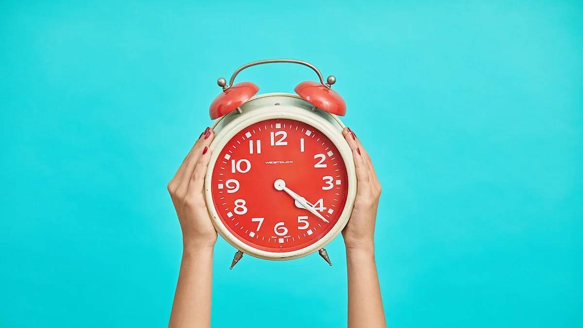 person holding red and beige twin bell analog alarm clock — a Sleep, Finally guide to Why Spring Forward Feels Worse Than Fall Back