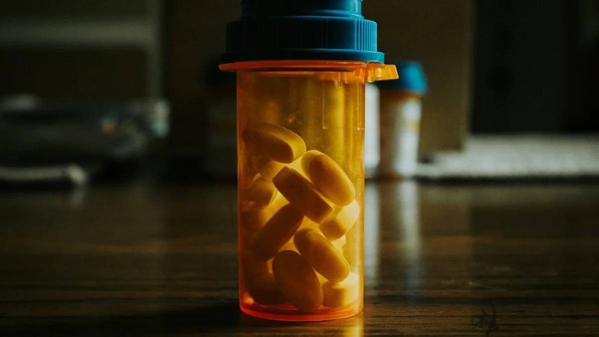 a bottle filled with pills sitting on top of a wooden table — a Sleep, Finally guide to Why You Should Never Quit Sleep Meds Cold Turkey